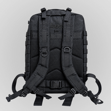 Rear view of the Anenberg Black Out Pack Out Tactical Backpack featuring an all-black design with breathable padded mesh back panels, adjustable cushioned shoulder straps, and a secure waist strap with quick-release buckle. Custom black-on-black Anenberg Single Story logo embroidery accents the upper back panel, while reinforced webbing, metal D-ring attachment points, and adjustable support straps highlight the functional tactical construction. Rugged everyday carry backpack from Southern California street